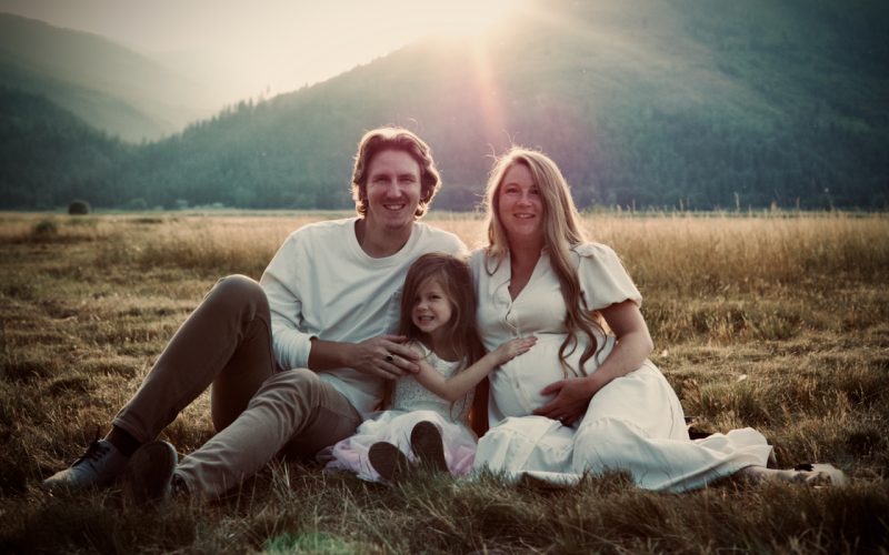 Family portrait in a golden meadow at sunset
